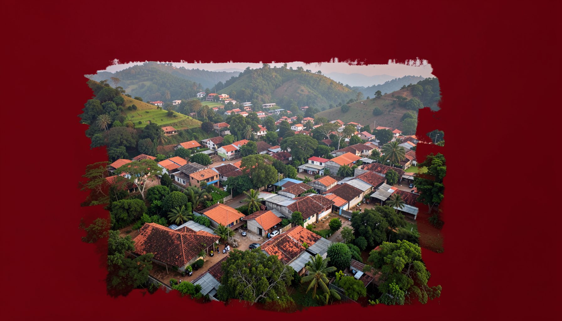 Aerial view of a southeastern Nigerian town nestled among green hills, terracotta rooftops, hazy morning light